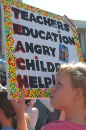 Youth holding sign at education rally